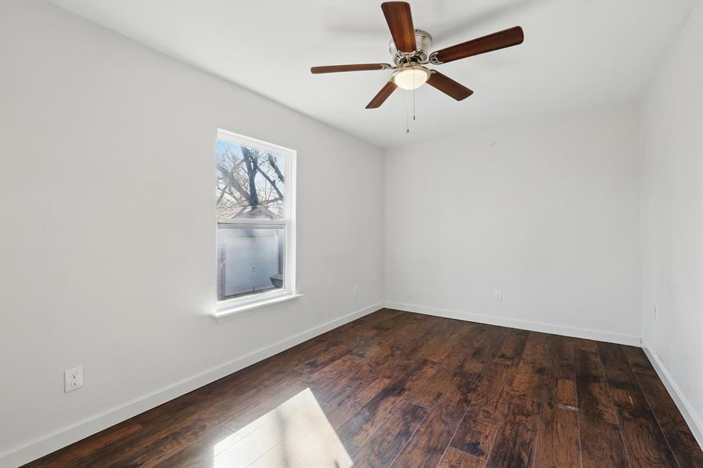 1805 Daniel Street Fort Worth, TX 76104 - Photo 32 of 38 an empty room with a window and a ceiling fan
