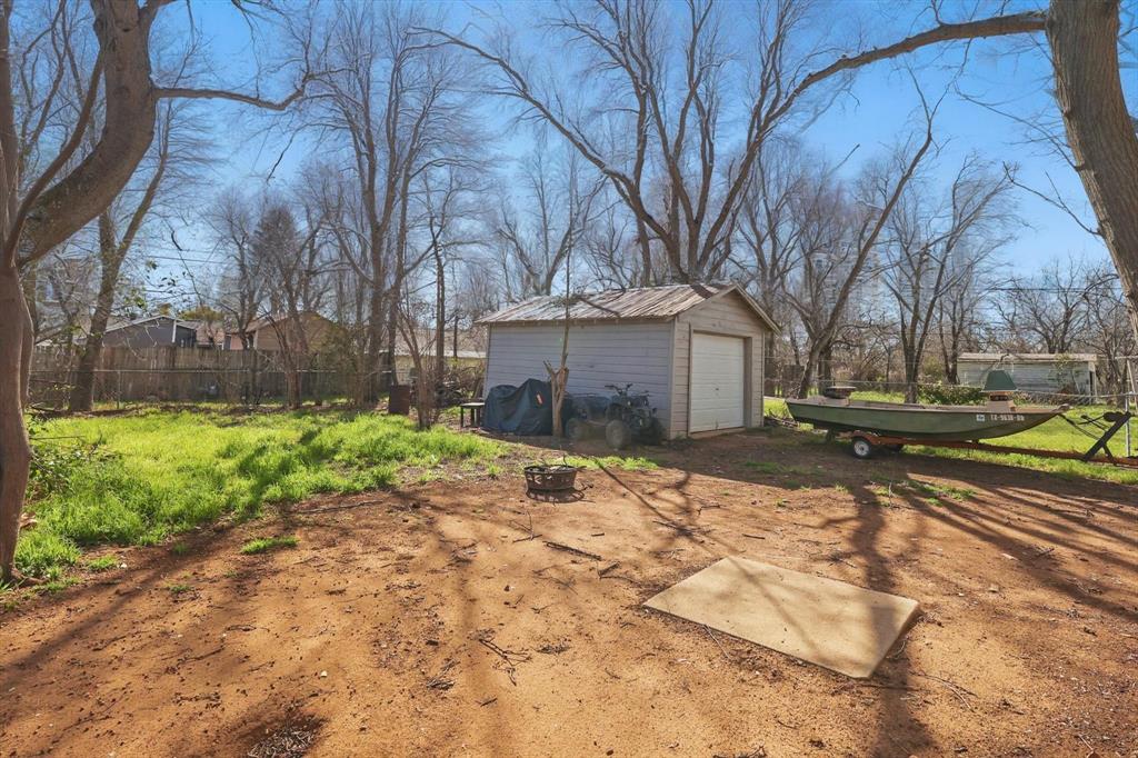 1805 Daniel Street Fort Worth, TX 76104 - Photo 35 of 38 a front view of a house with a yard and garage