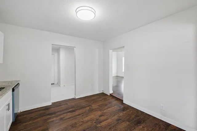 a view of an empty room and wooden floor