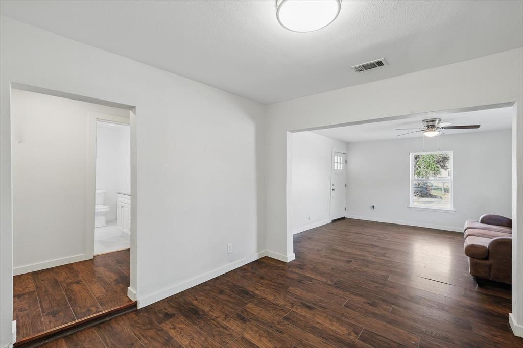 1805 Daniel Street Fort Worth, TX 76104 - Photo 9 of 38 a view of an empty room and wooden floor