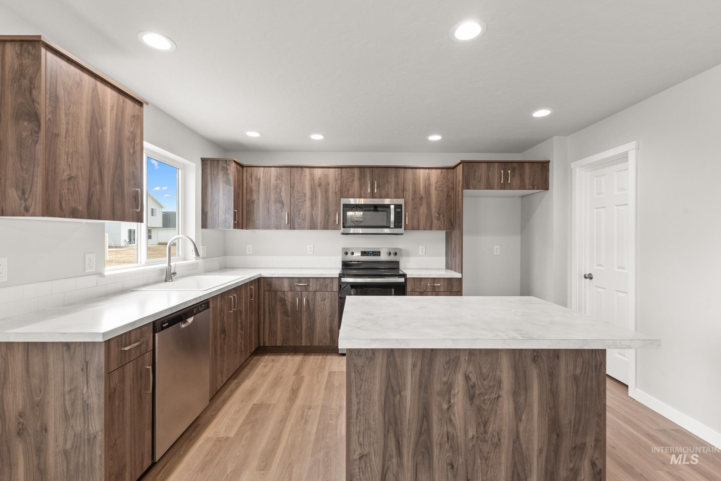 461 Waverly Avenue Middleton, ID 83644 - Photo 4 of 22 Kitchen featuring light countertops, stainless steel appliances, light wood-style floors, a center island, and modern cabinets