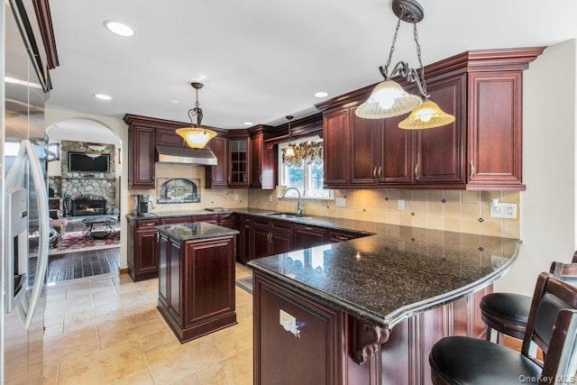 1509 Wad Riv Mnrvl Road Wading River, NY 11792 - Photo 9 of 19 a kitchen with stainless steel appliances granite countertop a sink a stove and a wooden floors