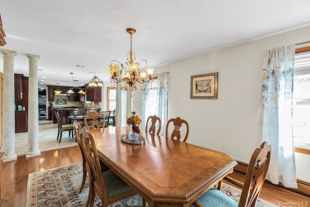 1509 Wad Riv Mnrvl Road Wading River, NY 11792 - Photo 10 of 19 a view of a dining room with furniture and chandelier