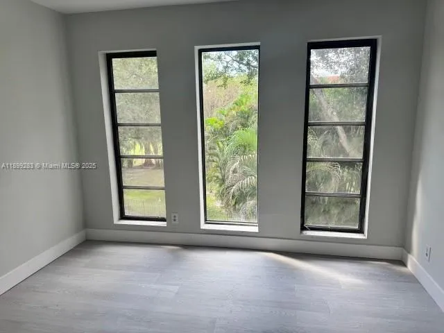 an empty room with windows and closet