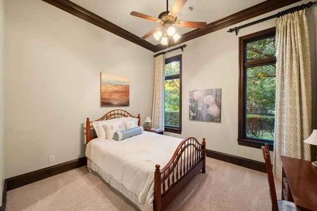 a bedroom with a large bed and a chandelier