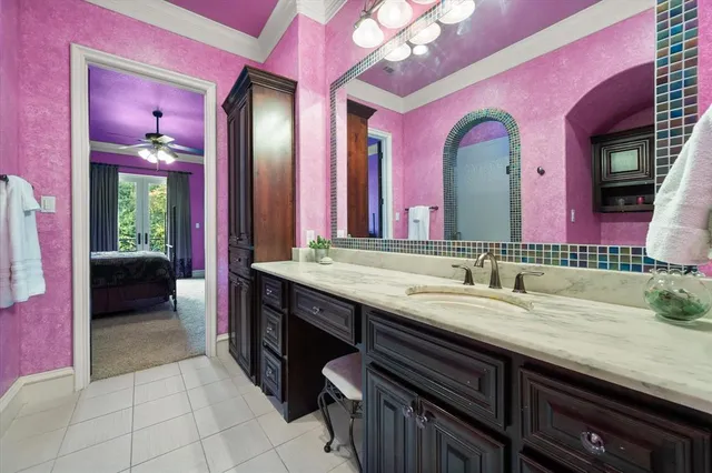 a bathroom with a sink a vanity and a large mirror