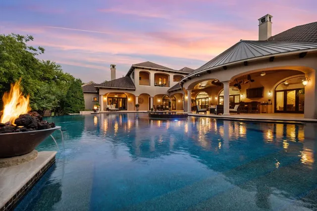 a front view of a house with yard and lake view