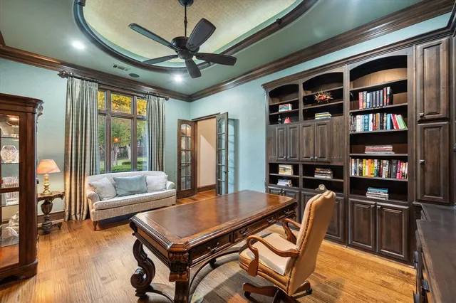 a living room with furniture a bookshelf and a large window