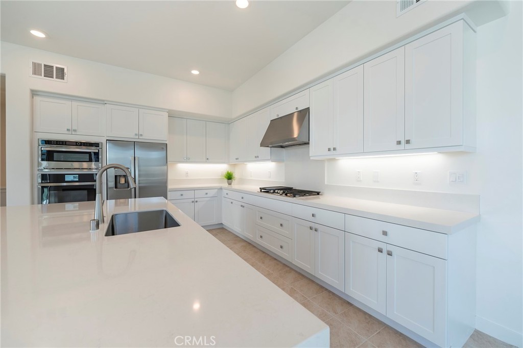 121 Baluster Irvine, CA 92618 - Photo 8 of 80 a kitchen with cabinets a sink and appliances