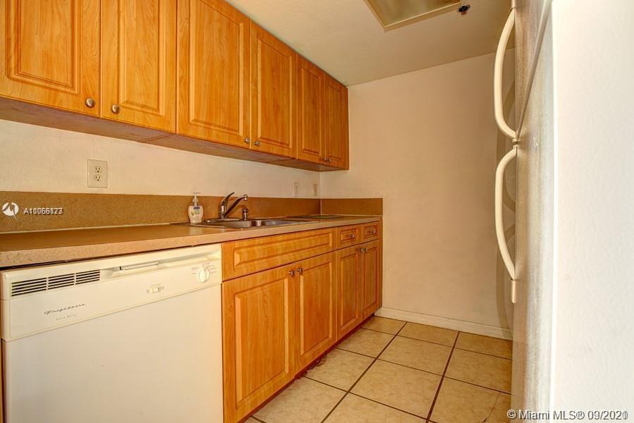 637 Southwest 3rd Street, Unit 206 Miami, FL 33130 - Photo 18 of 20 a kitchen with stainless steel appliances granite countertop a sink and cabinets