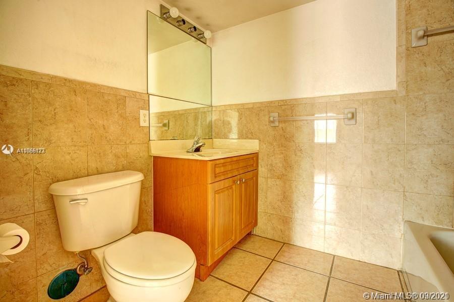 637 Southwest 3rd Street, Unit 206 Miami, FL 33130 - Photo 4 of 20 a bathroom with a toilet a sink and a shower