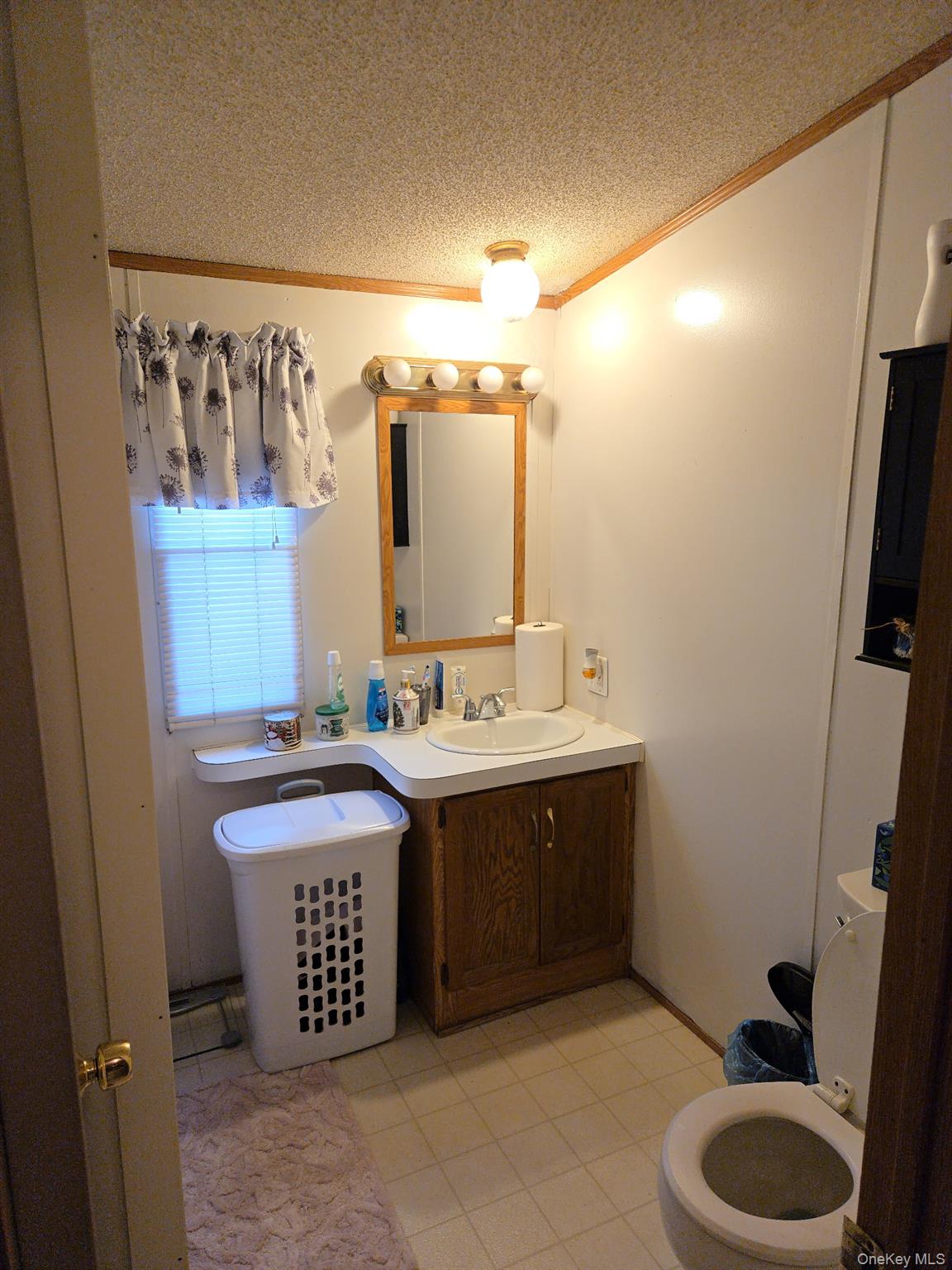 2701 Goethals Road North, Unit H4 Staten Island, NY 10303 - Photo 12 of 14 a bathroom with a sink and a mirror
