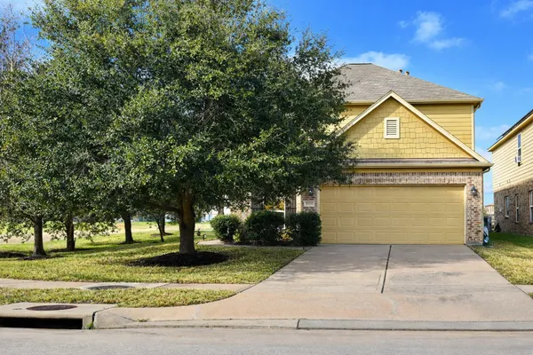 a view of a house with a yard and tree s
