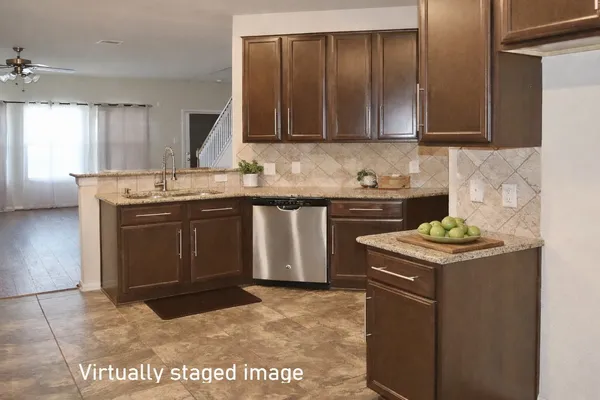 a kitchen with granite countertop cabinets stainless steel appliances and a counter space