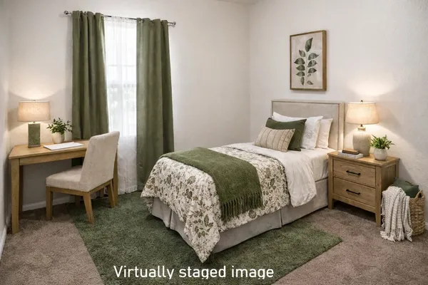 a bedroom with a bed a mirror and a potted plant