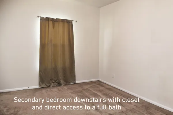 a bedroom with a bed a mirror and a potted plant