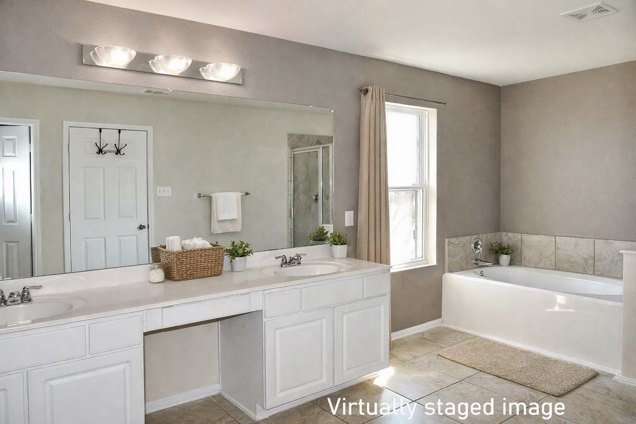19211 Side Way Tomball, TX 77375 - Photo 27 of 36 a bathroom with a double vanity sink a mirror and a bathtub