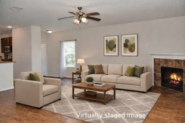 an empty room with windows and fireplace