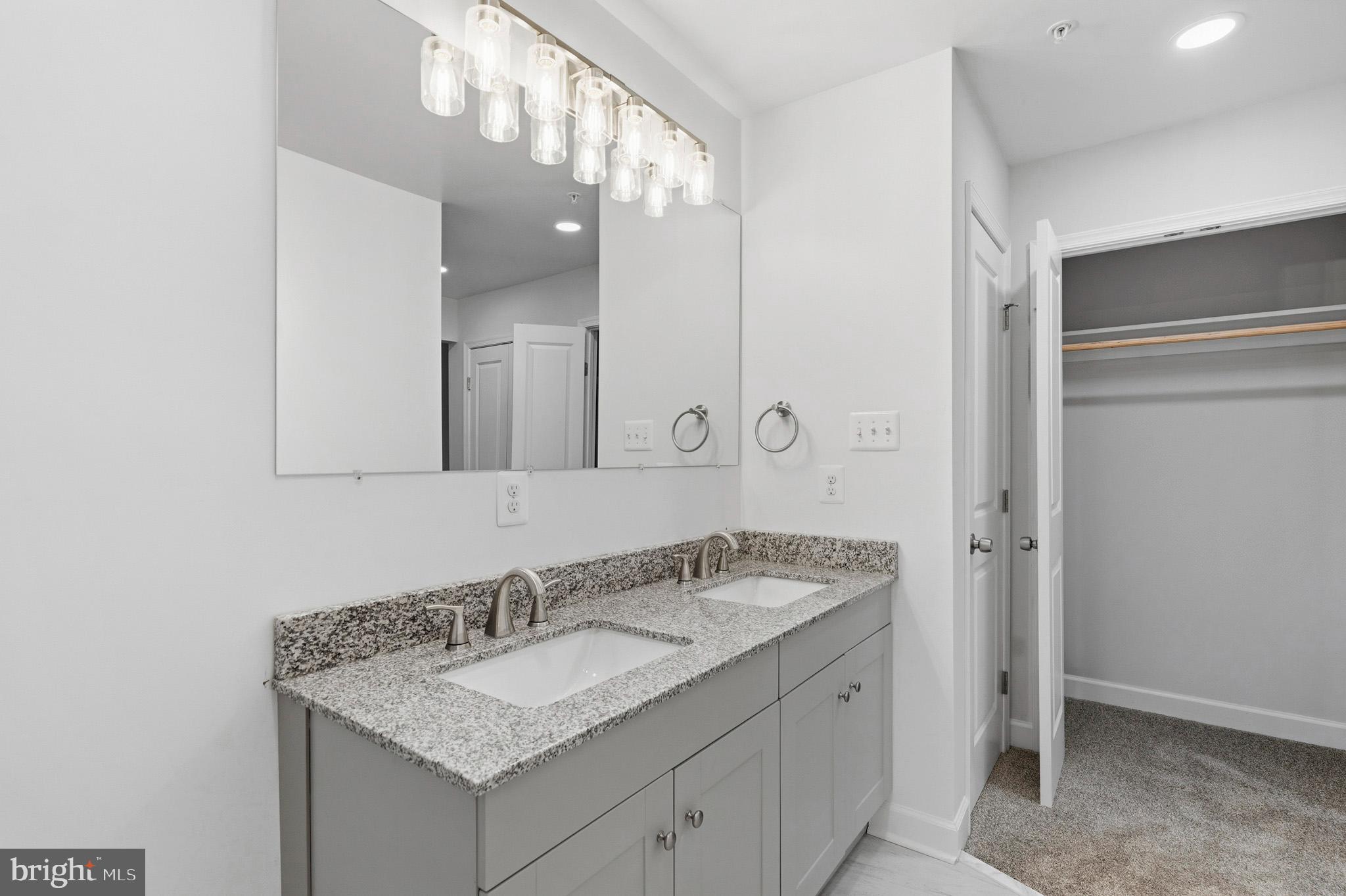 29725 Bruce Road Mechanicsville, MD 20659 - Photo 59 of 79 a bathroom with a granite countertop sink and a mirror