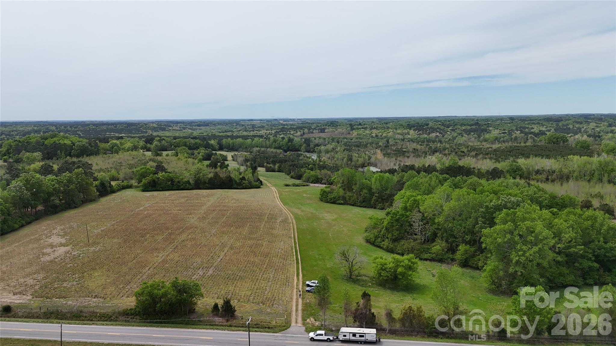 an aerial view of a house with a yard and lake view