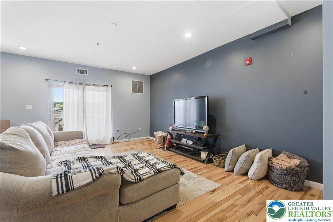 623 Walnut Street, Unit A2 Easton, PA 18042 - Photo 2 of 21 a bedroom with furniture and a flat screen tv