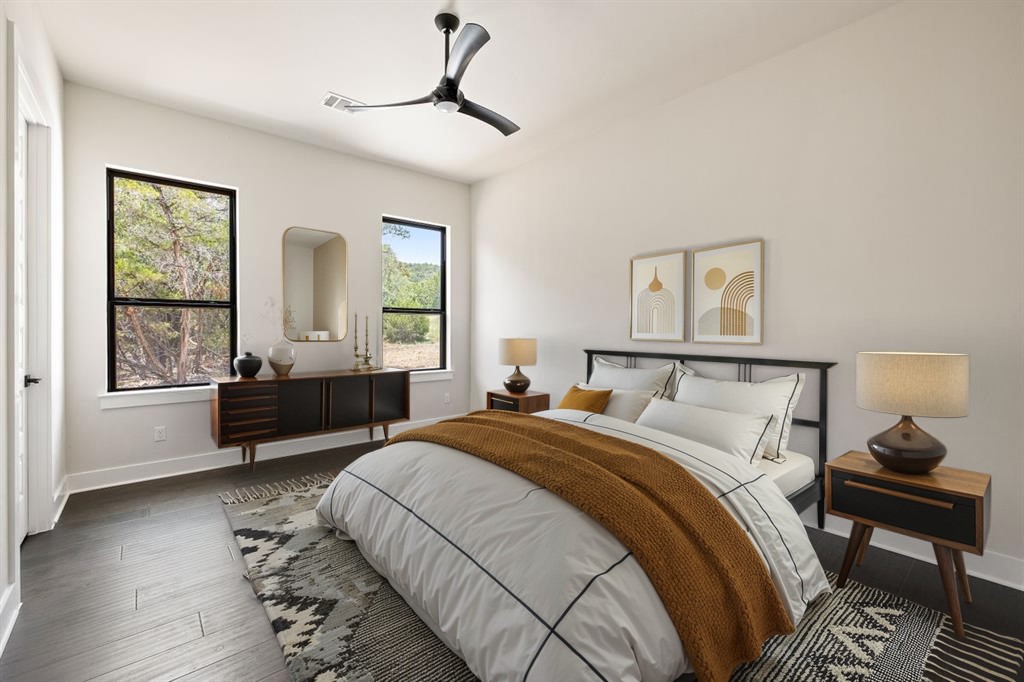 17809 Maritime Point Jonestown, TX 78645 - Photo 13 of 26 a bedroom with a bed and wooden floor