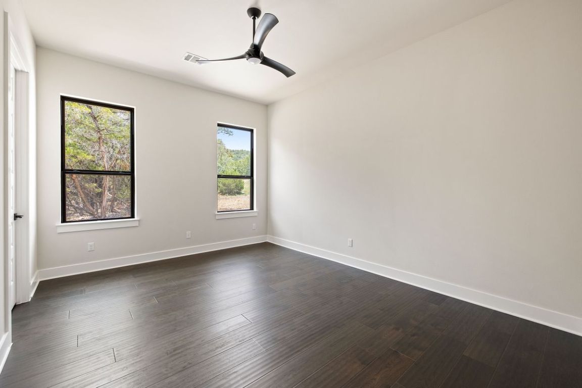 17809 Maritime Point Jonestown, TX 78645 - Photo 22 of 26 a view of an empty room with wooden floor and a window