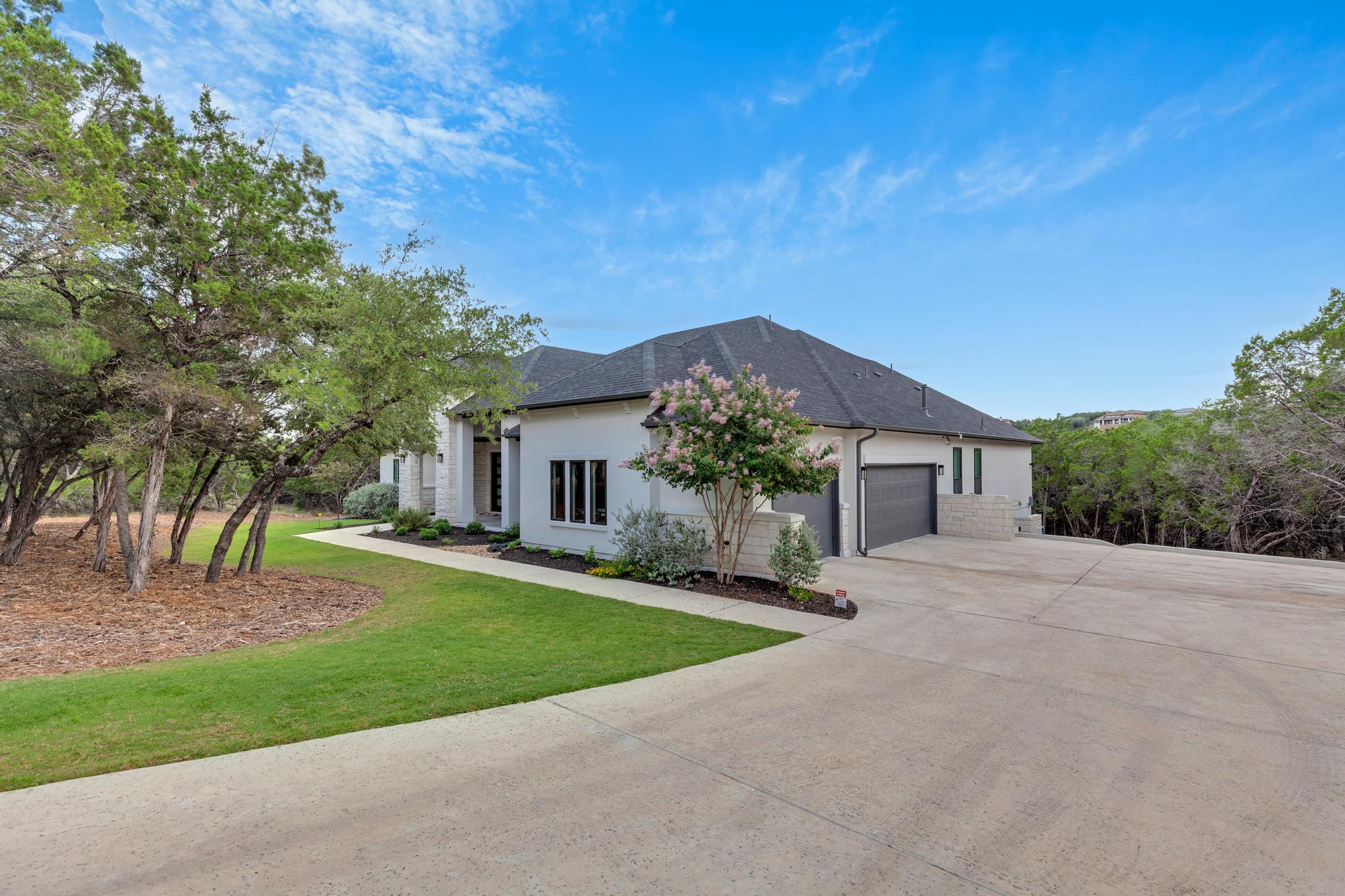 17809 Maritime Point Jonestown, TX 78645 - Photo 25 of 26 front view of a house with a yard and an trees