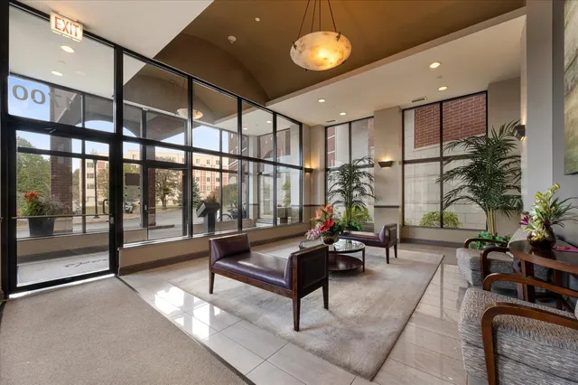 a living room with furniture gym equipment and a large window