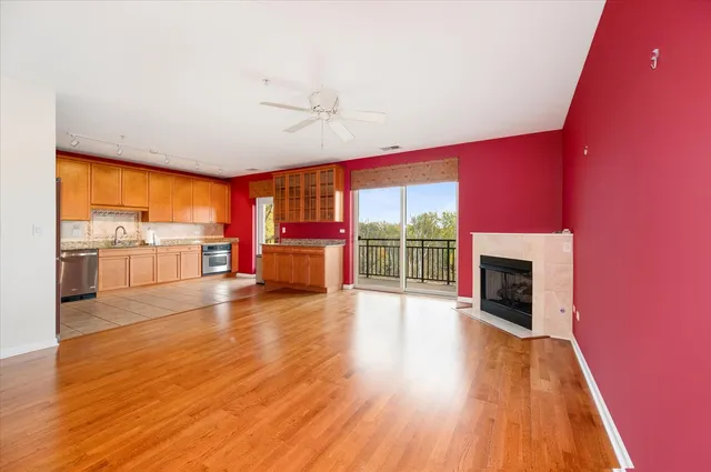 a view of a living room with a fireplace and wooden floor