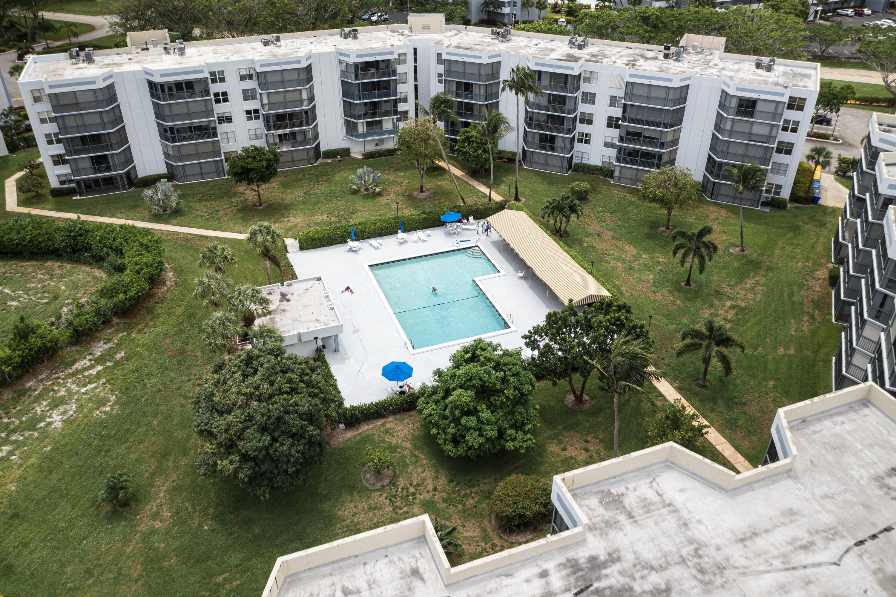 198 Northwest 67th Street, Unit 302 Boca Raton, FL 33487 - Photo 29 of 32 drone over building & pool