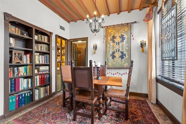 a dining room with furniture and chandelier