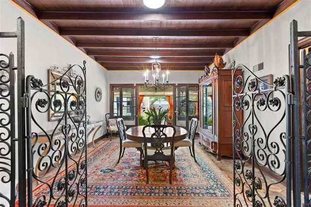 a dining room with furniture and a chandelier