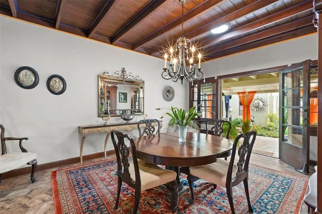 a view of a dining room with furniture and chandelier