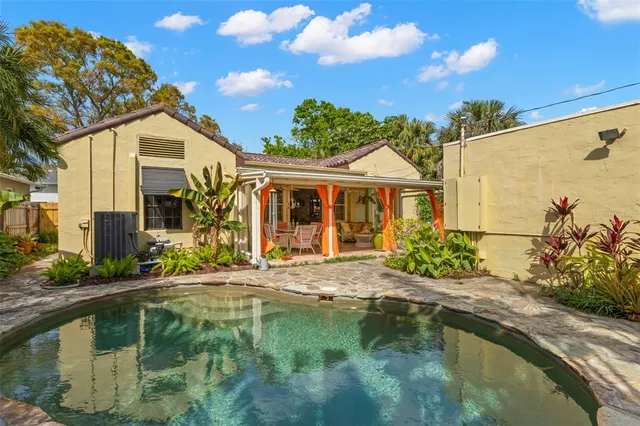 a house with swimming pool in front of it