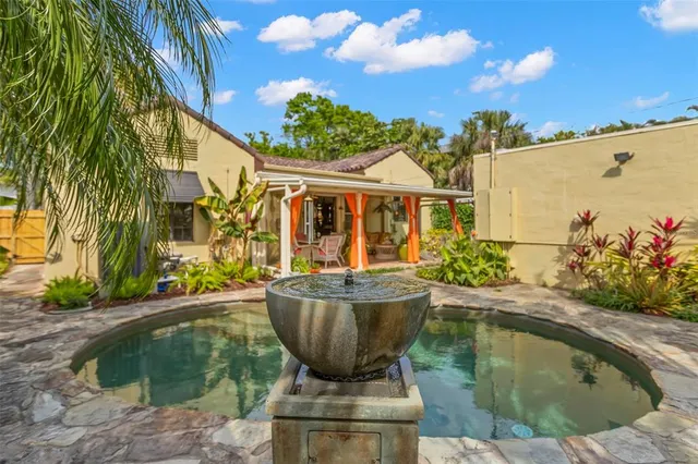 a view of a swimming pool with potted plants