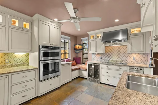 a kitchen with a stove a faucet and a refrigerator