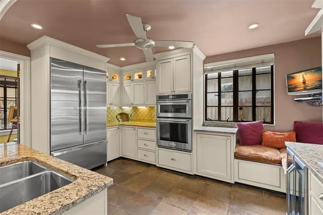 a kitchen with a refrigerator sink and cabinets