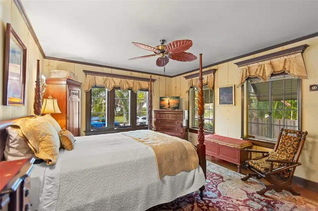 a bed room with a bed mirror and a window