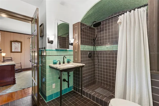 a bedroom with a bed and a chandelier