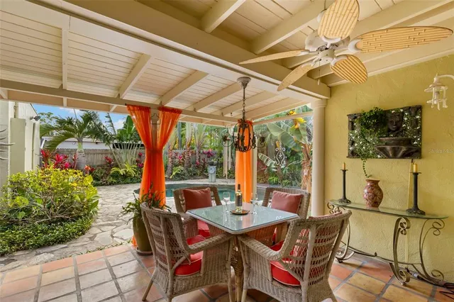 a view of an outdoor dining space with a table and chairs