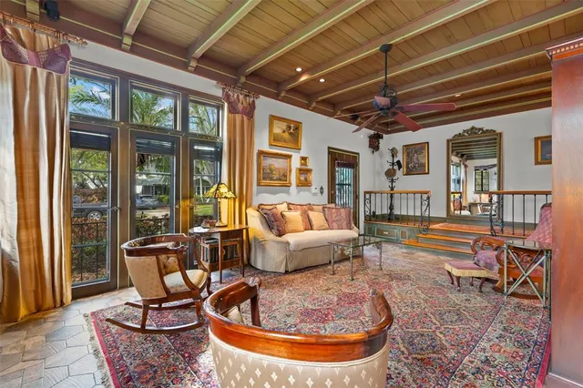 a dining room with furniture wooden floor and a chandelier
