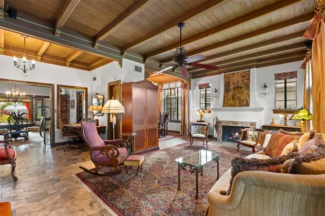 a living room with furniture a dining table and chairs