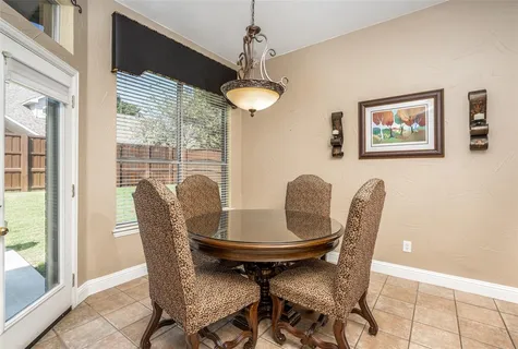 a view of a dining room with furniture wooden floor and a chandelier