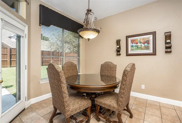 a view of a dining room with furniture wooden floor and a chandelier
