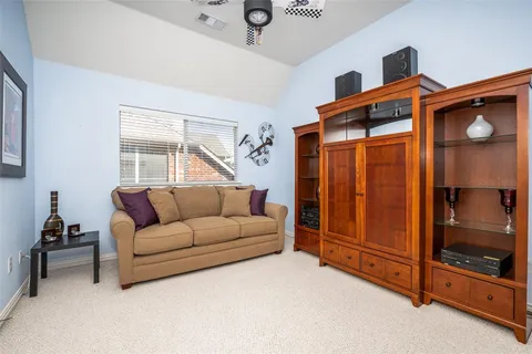 a living room with furniture a ceiling fan and a window