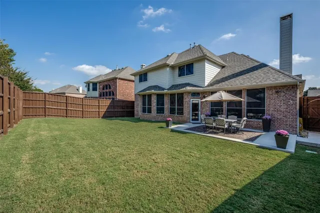 a view of a house with backyard porch and sitting area