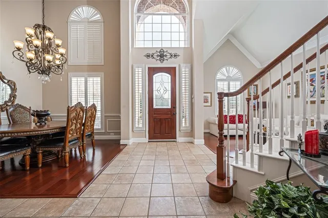 a view of a dining room with furniture and a chandelier
