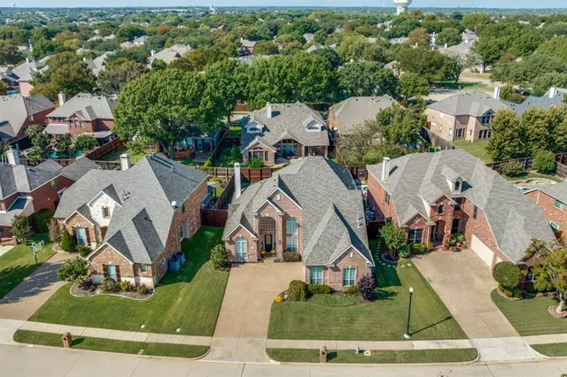 an aerial view of residential houses with outdoor space and street view