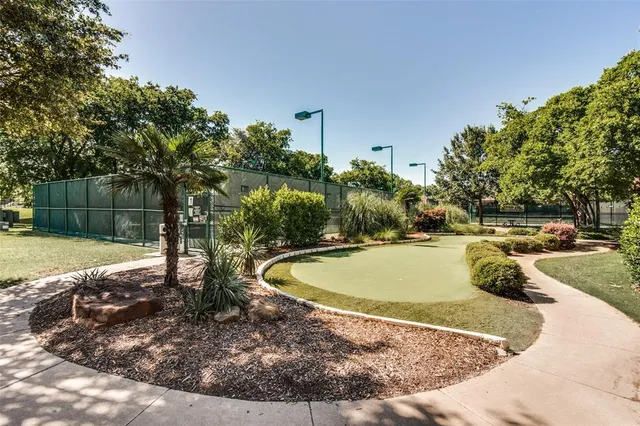 a view of a swimming pool with a patio and a yard